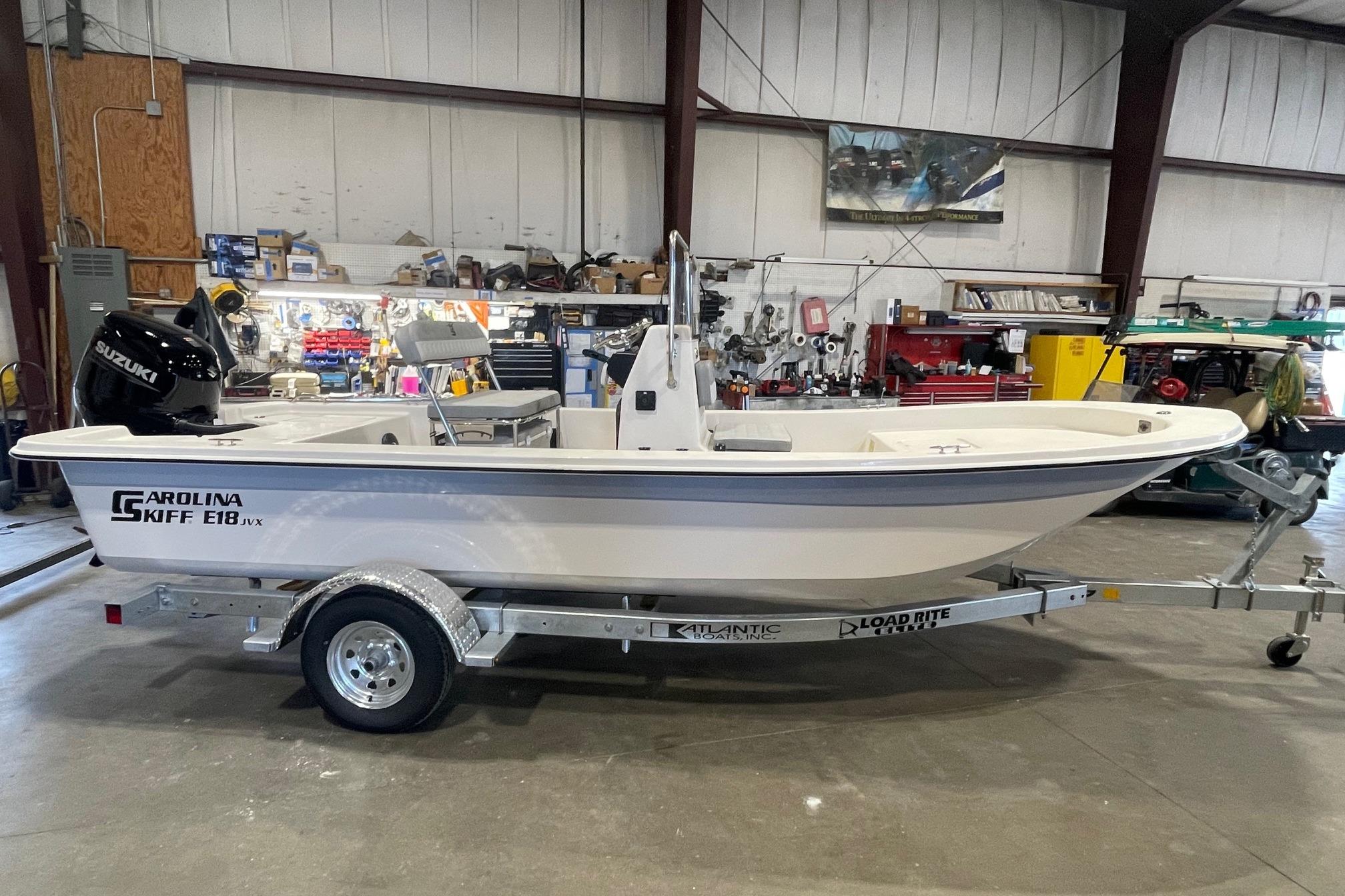 Carolina Skiff E18 JVX CC 2026 Carolina Skiff E18 JVX CC boat on trailer in a workshop setting.