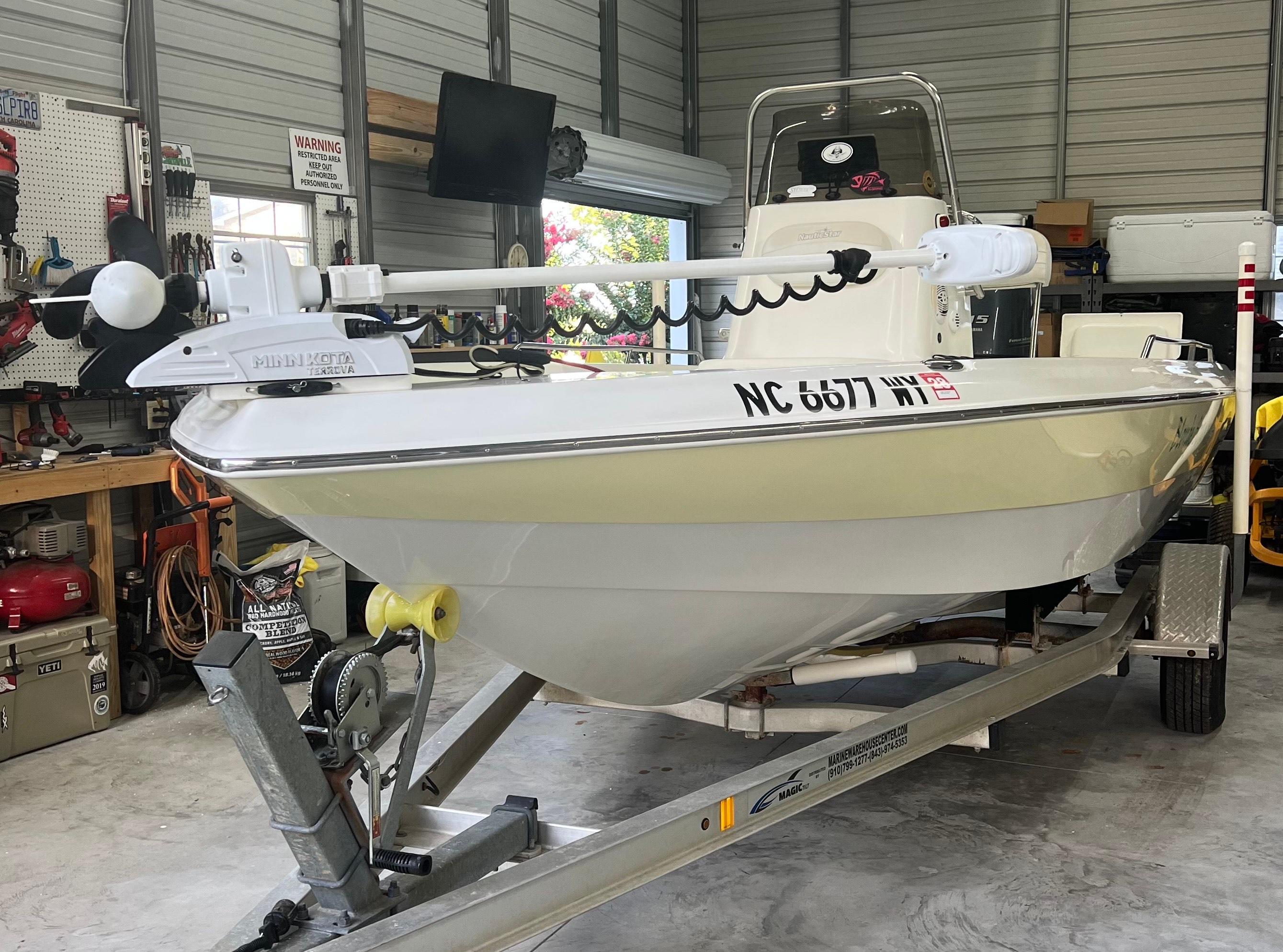 NauticStar 1900 BAY 2004 NauticStar 1900 BAY boat on trailer in garage with Minn Kota trolling motor.