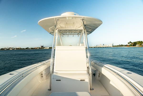 Contender 32 ST 2015 Contender 32 ST boat on calm water, clear sky, and distant shoreline.