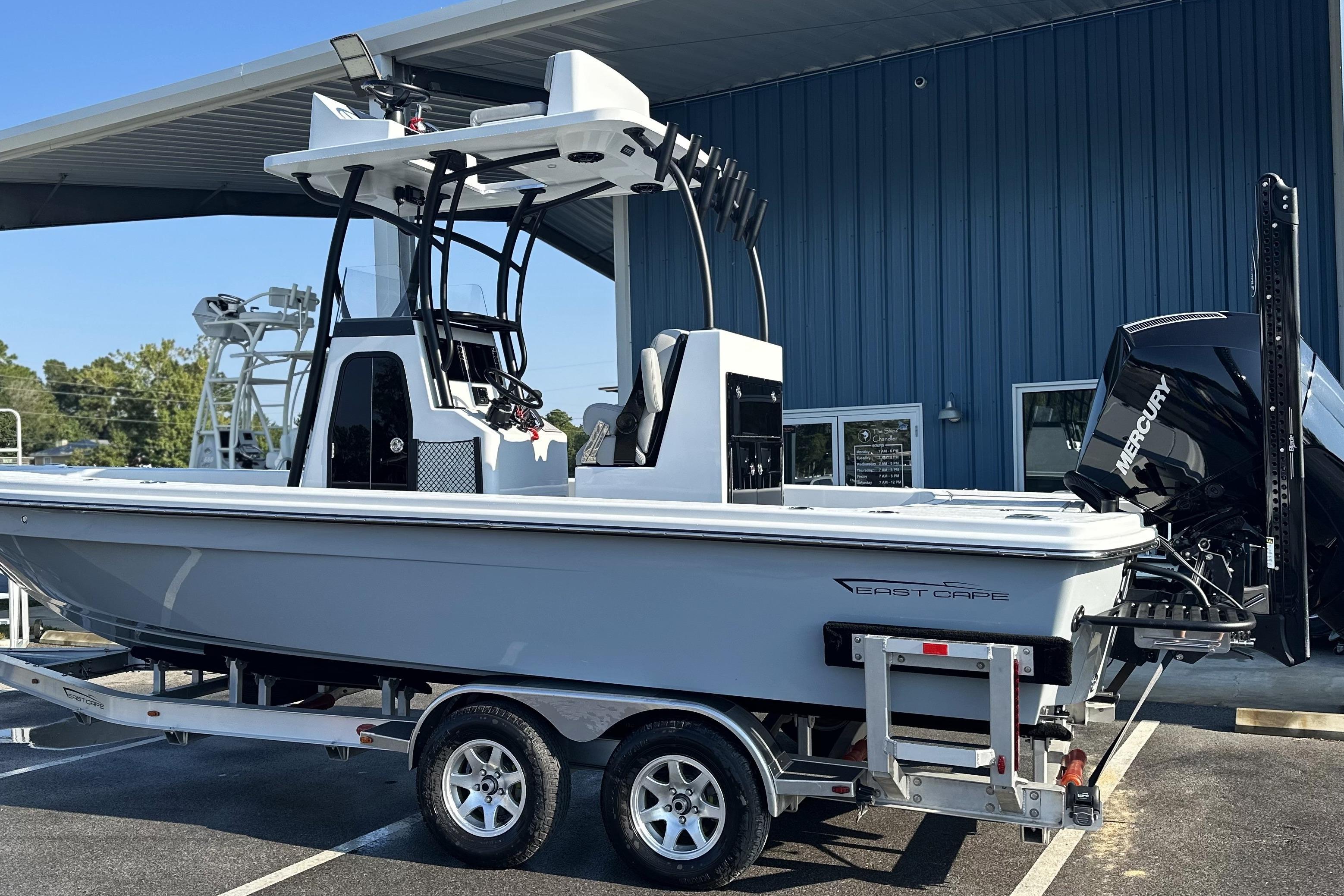 East Cape 25 Open 2025 East Cape 25 Open boat on trailer, parked outside a blue building.
