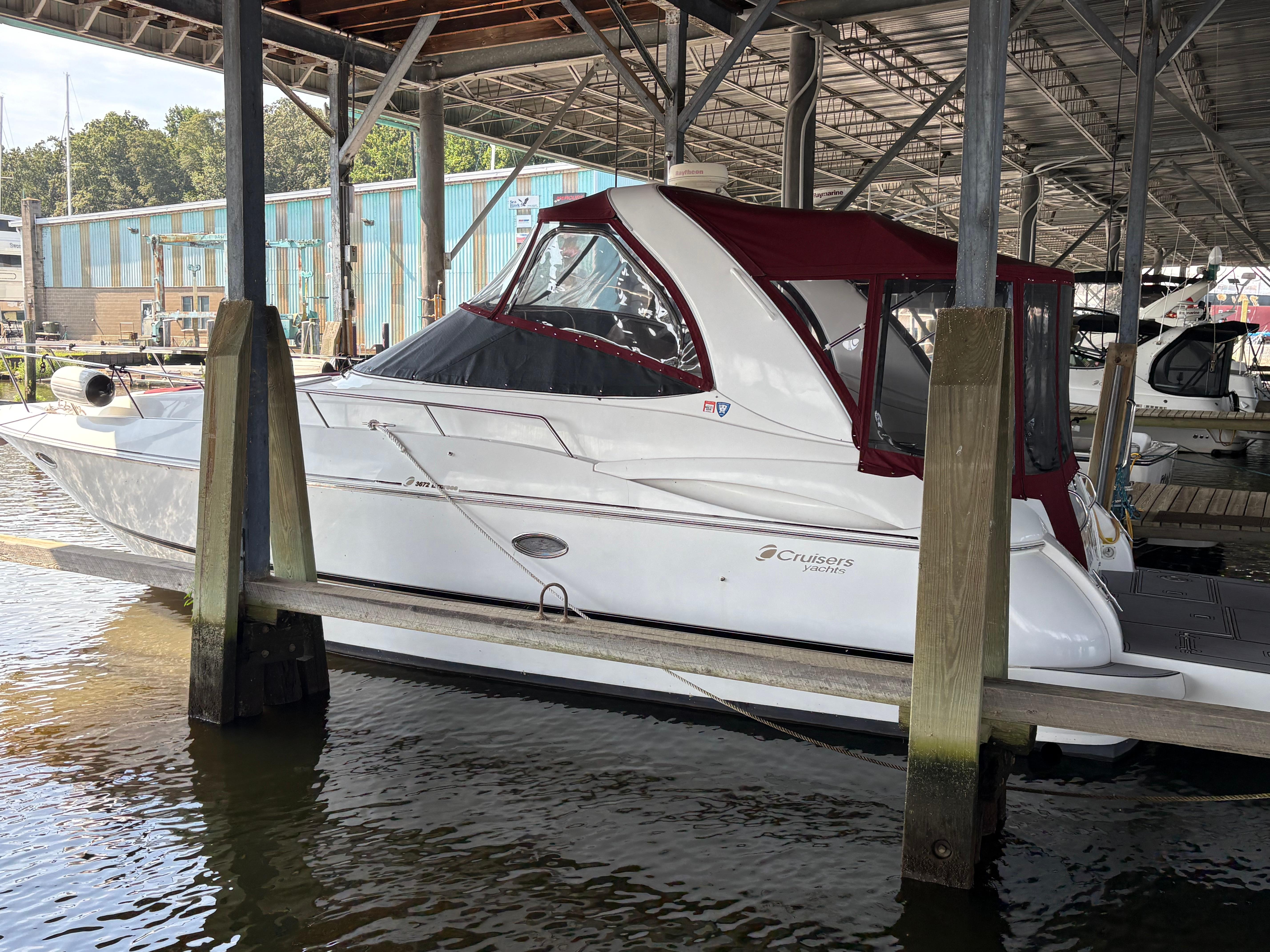 Cruisers 3672 Express 2001 Cruisers 3672 Express yacht docked under a covered marina.