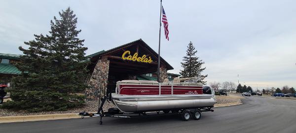 Sun Tracker Party Barge 22 XP3 2024 Sun Tracker Party Barge 22 XP3 pontoon boat outside Cabela's store.