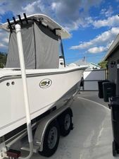 Sea Hunt Ultra 265 SE 2023 Sea Hunt Ultra 265 SE boat on trailer under a blue sky.