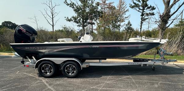 Ranger RB200 2024 Ranger RB200 boat on trailer, parked outdoors, side view.