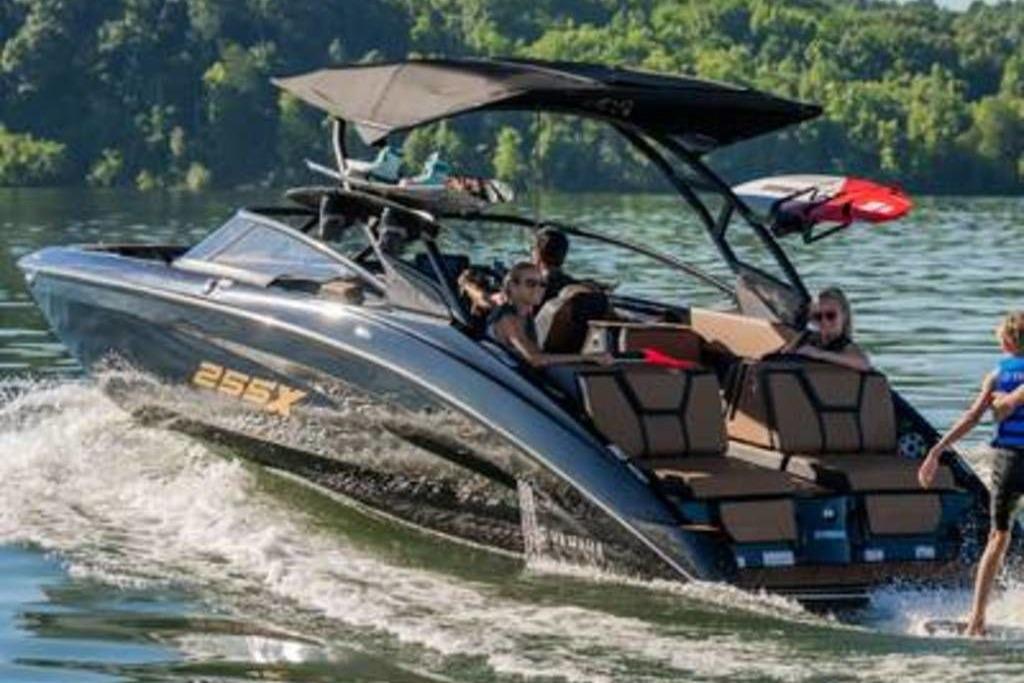 Yamaha Boats 255XD 2026 Yamaha Boats 255XD cruising on a lake with passengers enjoying the ride.