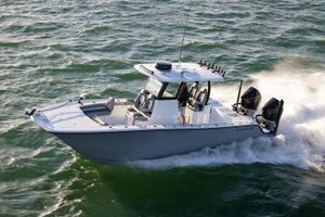 Freeman 28 2026 Freeman 28 boat cruising on open water, featuring dual outboard engines.
