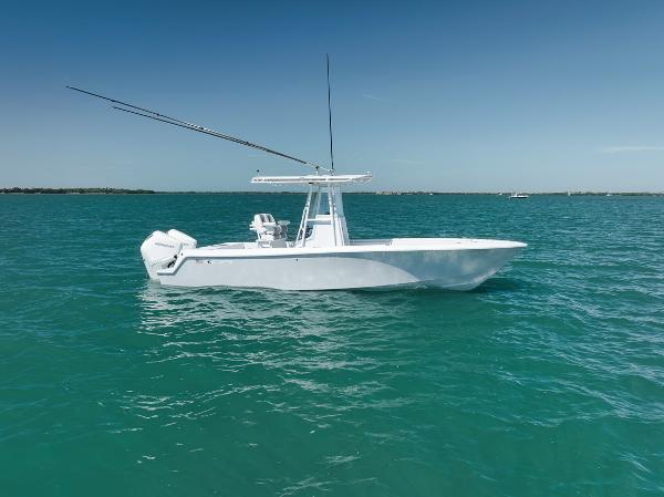 Contender 25 Tournament 2004 Contender 25 Tournament boat on turquoise water under clear blue sky.