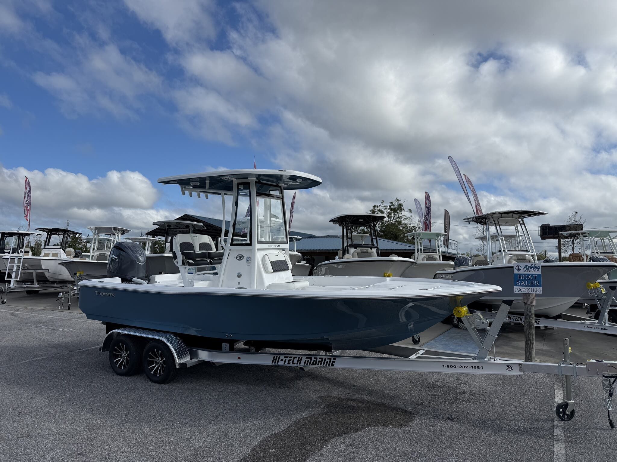 Tidewater 2210 Carolina Bay 2026 Tidewater 2210 Carolina Bay boat on trailer under cloudy sky at dealership.