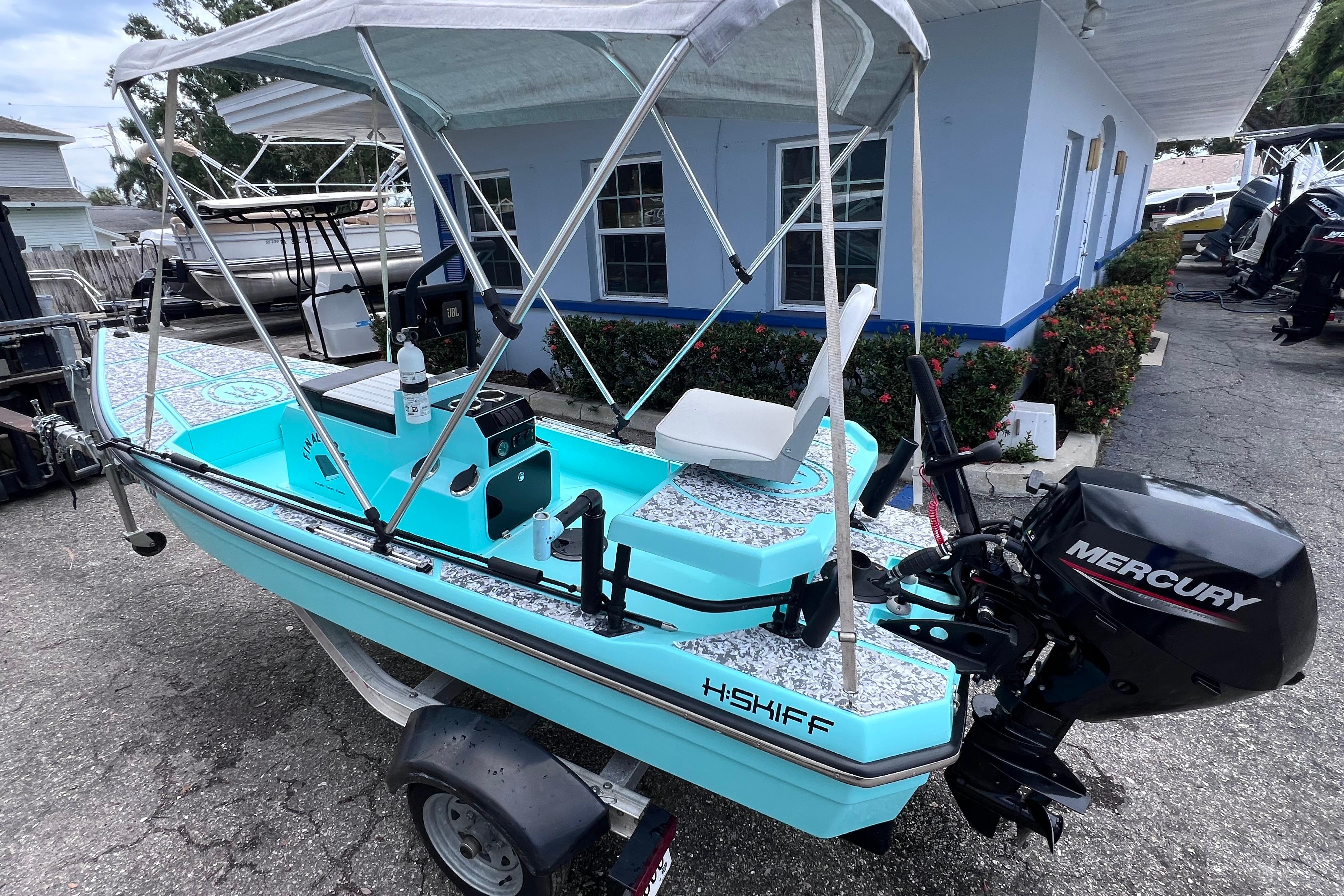 Custom H:Craft 13 Micro Skiff 2021 HCraft 13 Skiff boat with Mercury engine, parked on a trailer.