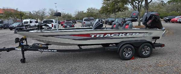 Tracker Savage 215 2025 Tracker Savage 215 boat on trailer in parking lot.