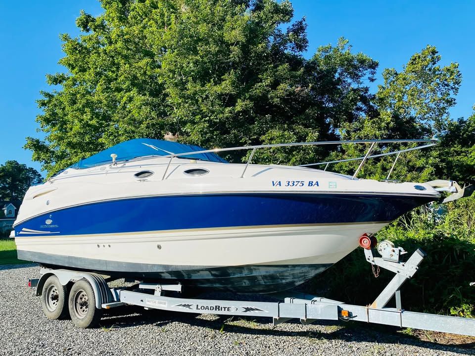 Chaparral Signature 240 2006 Chaparral Signature 240 boat on trailer, parked outdoors with trees in background.