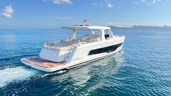 Fjord 53 XL 2023 Fjord 53 XL yacht cruising on open sea under clear blue sky.