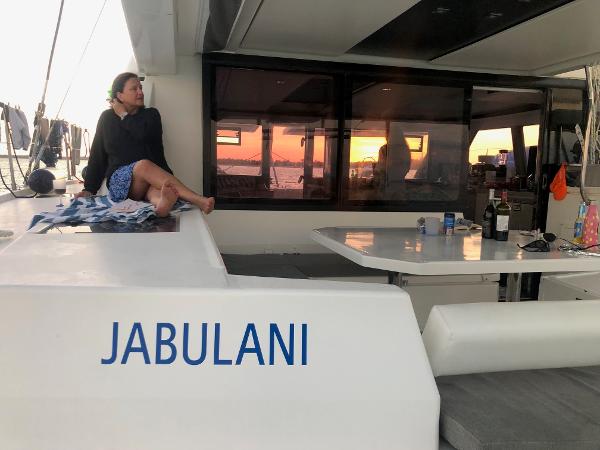 Leopard 45 Woman relaxing on Leopard 45 catamaran named Jabulani at sunset, 2020.