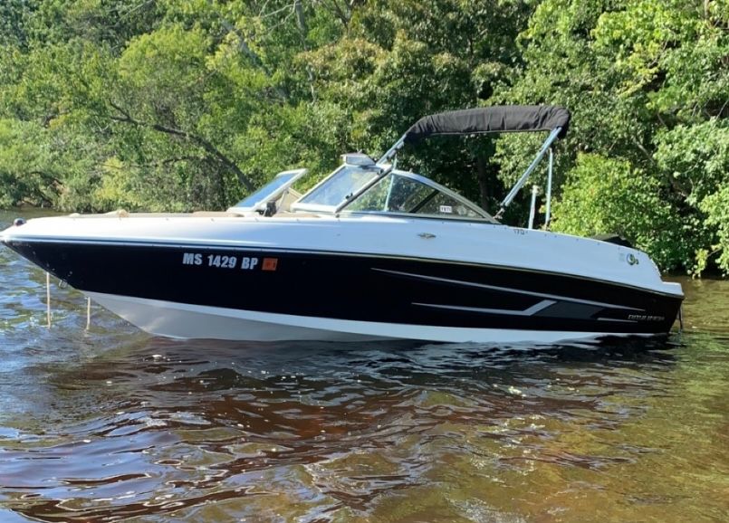 Bayliner 170 Bowrider 2015 Bayliner 170 Bowrider boat on water, surrounded by lush greenery.