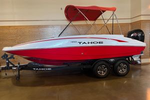 Tahoe 1950 2025 Tahoe 1950 boat with red and white design, on a trailer indoors.