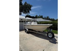 Key West 196 Bay Reef 2005 Key West 196 Bay Reef boat on trailer, parked in driveway under clear blue sky.