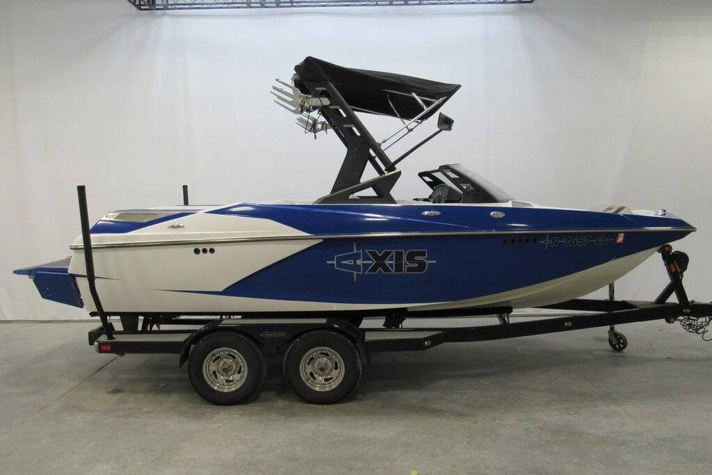 Axis A20 2016 Axis A20 boat in blue and white on a trailer, side view.