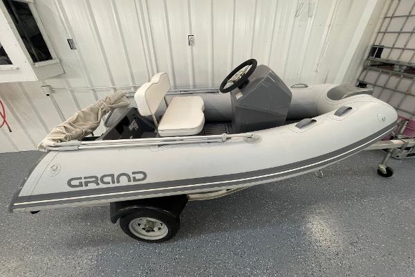 Grand Inflatables S300L 2022 Grand Inflatables S300L boat in a garage on a trailer.