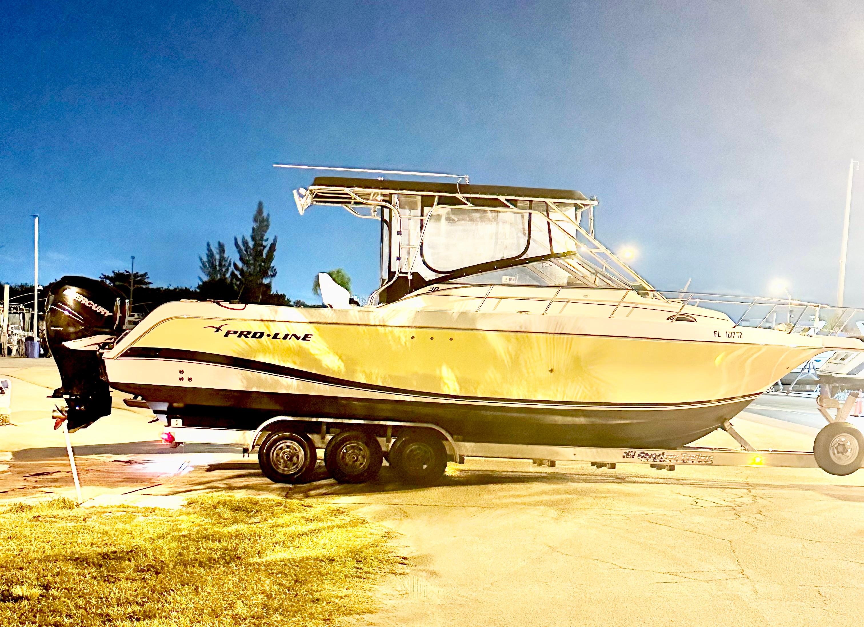 Pro-Line 30 Express Walkaround 2004 Pro-Line 30 Express Walkaround boat on trailer at dusk.