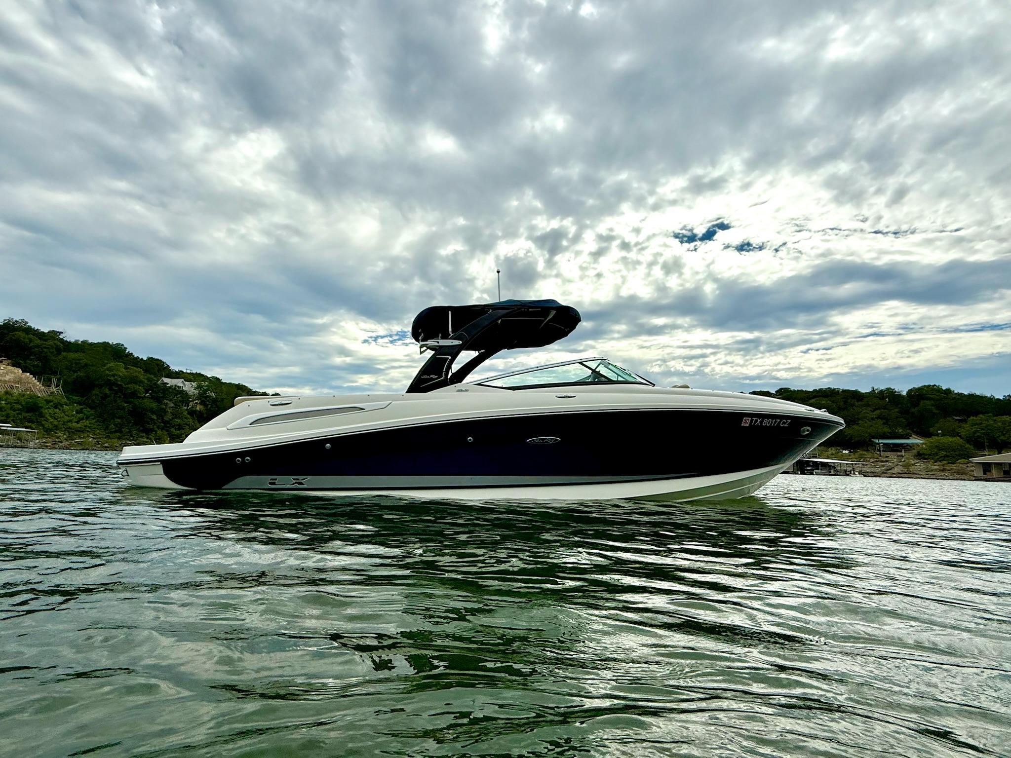 Sea Ray 250 SLX 2013 Sea Ray 250 SLX boat on water under cloudy sky.
