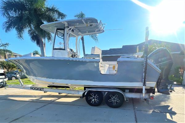 Sea Hunt 255 Ultra 2019 Sea Hunt 255 Ultra boat on a trailer in a sunny driveway.