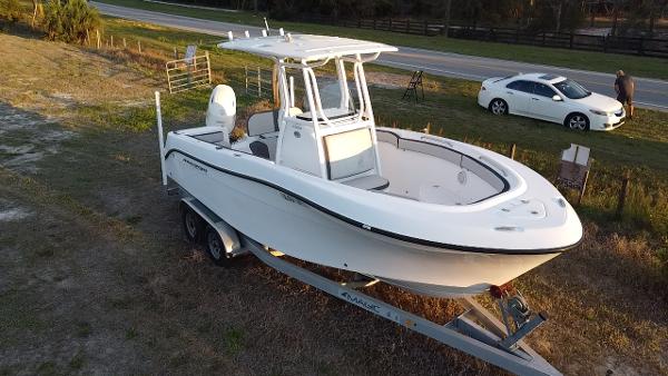 Aquasport 2300 Center Console 2020 Aquasport 2300 Center Console boat on trailer, parked outdoors.