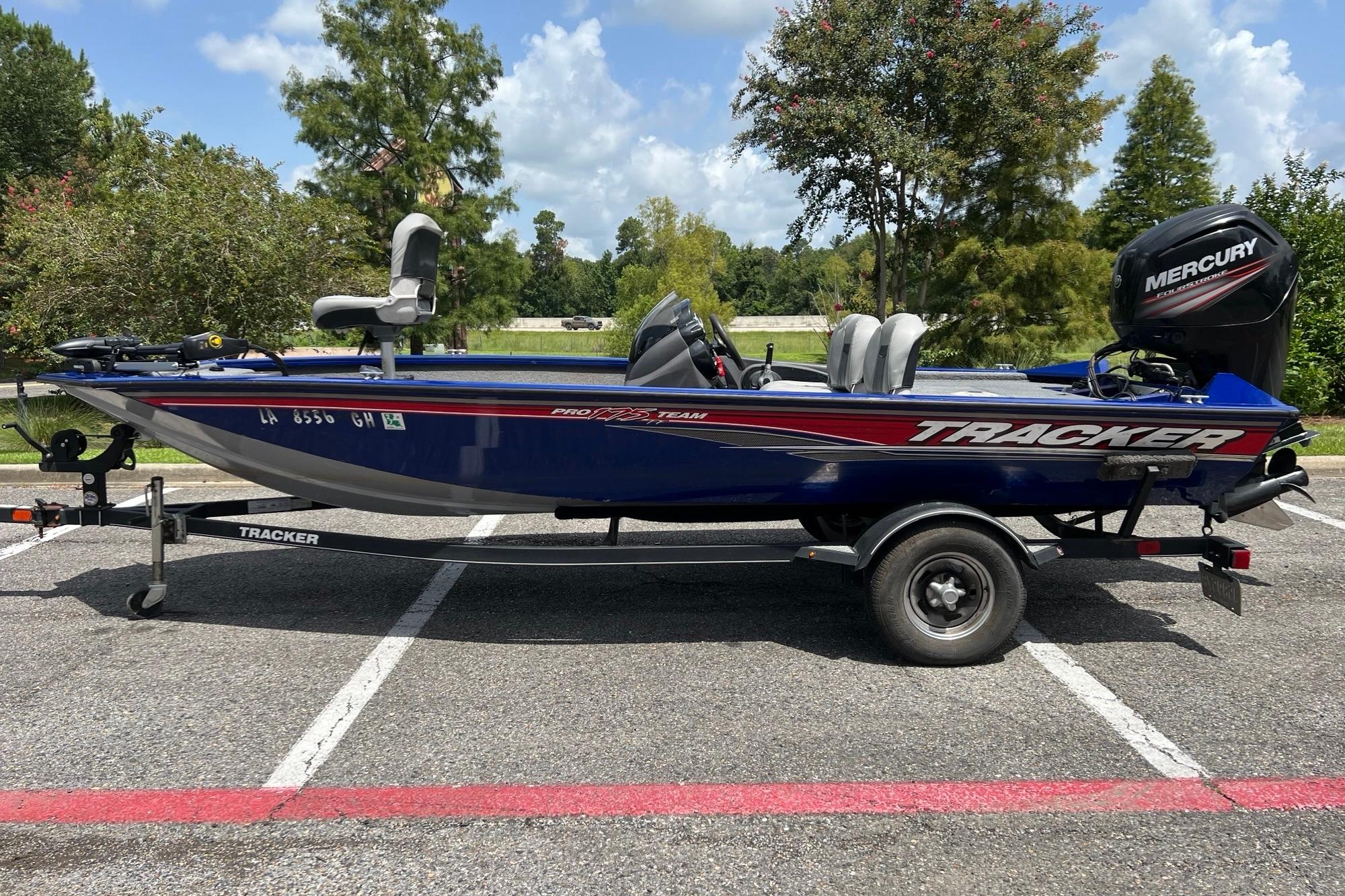 Tracker Pro Team 175 TF 2018 Tracker Pro Team 175 TF boat on trailer, parked outdoors with trees in background.