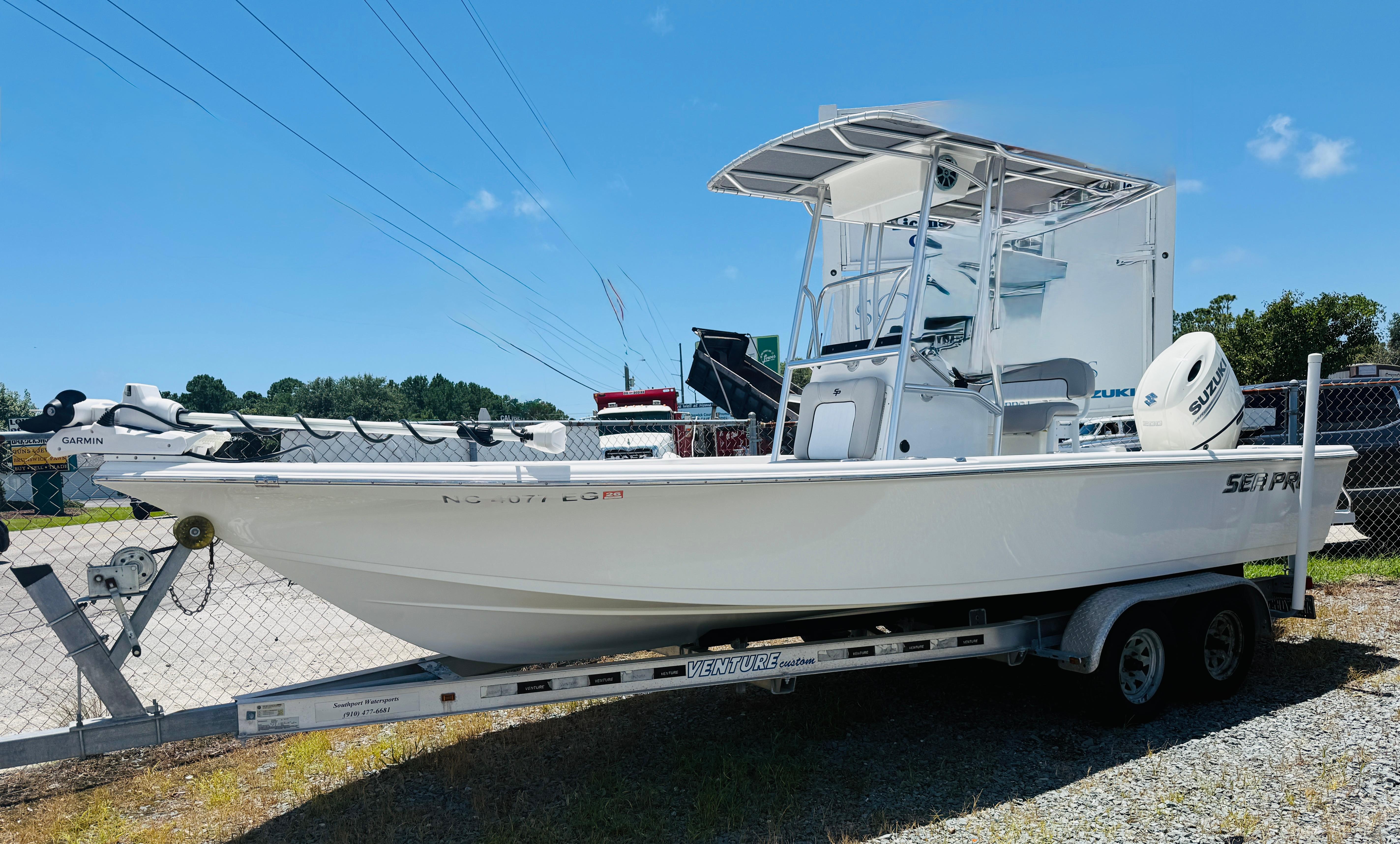 Sea Pro 228 Bay 2018 Sea Pro 228 Bay boat on trailer, equipped with Suzuki engine, parked outdoors.