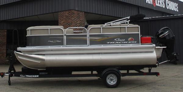 Sun Tracker Party Barge 16 DLX 2025 Sun Tracker PARTY BARGE® 16 DLX pontoon boat on trailer, side view.