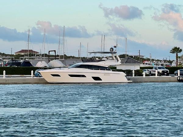 Ferretti Yachts 550 2016 Ferretti Yachts 550 docked at a marina with sailboats in the background.
