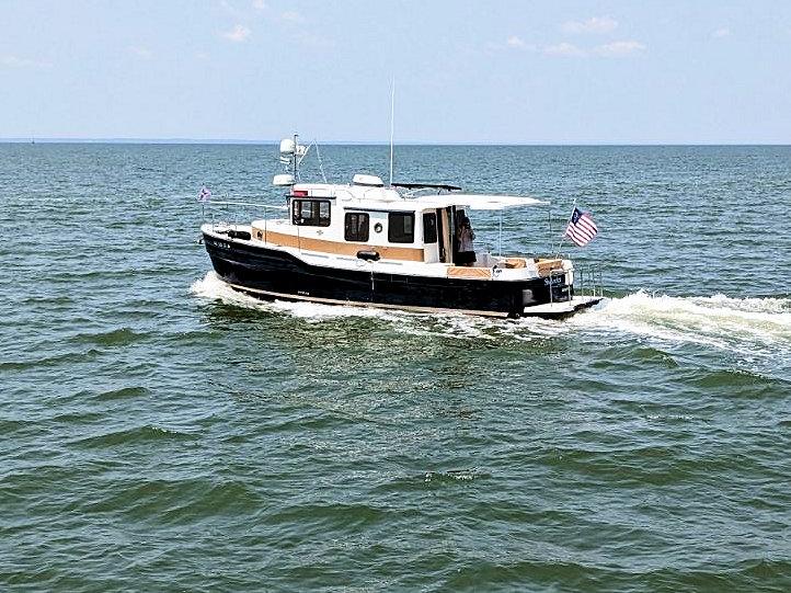 Ranger Tugs R-31S 2016 Ranger Tugs R-31S cruising on open water with American flag.