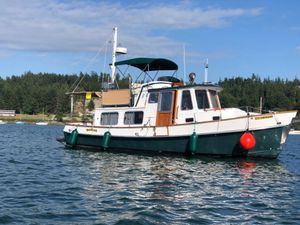 Eagle 32 Trawler 1989 Eagle 32 Trawler boat on water, with forested shoreline in background.