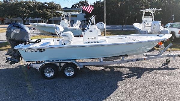 Frontier 2104 2025 Frontier 2104 boat on trailer with Yamaha engine, parked outdoors.