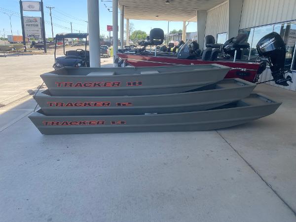 Tracker Grizzly 14 Jon Three 2025 Tracker Grizzly 14 Jon boats stacked outside a dealership.