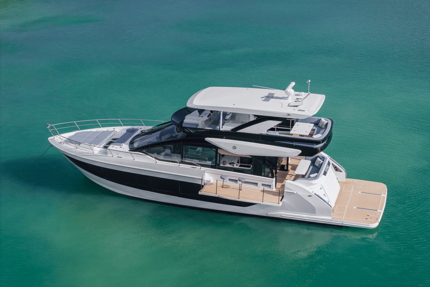 Cruisers Yachts 57 Fly 2026 Cruisers Yachts 57 Fly luxury yacht on turquoise water.