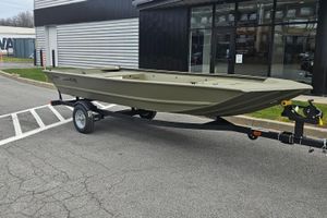 Tracker Grizzly 1648 Utility 2026 Tracker Grizzly 1648 Utility boat on trailer, parked outside dealership.