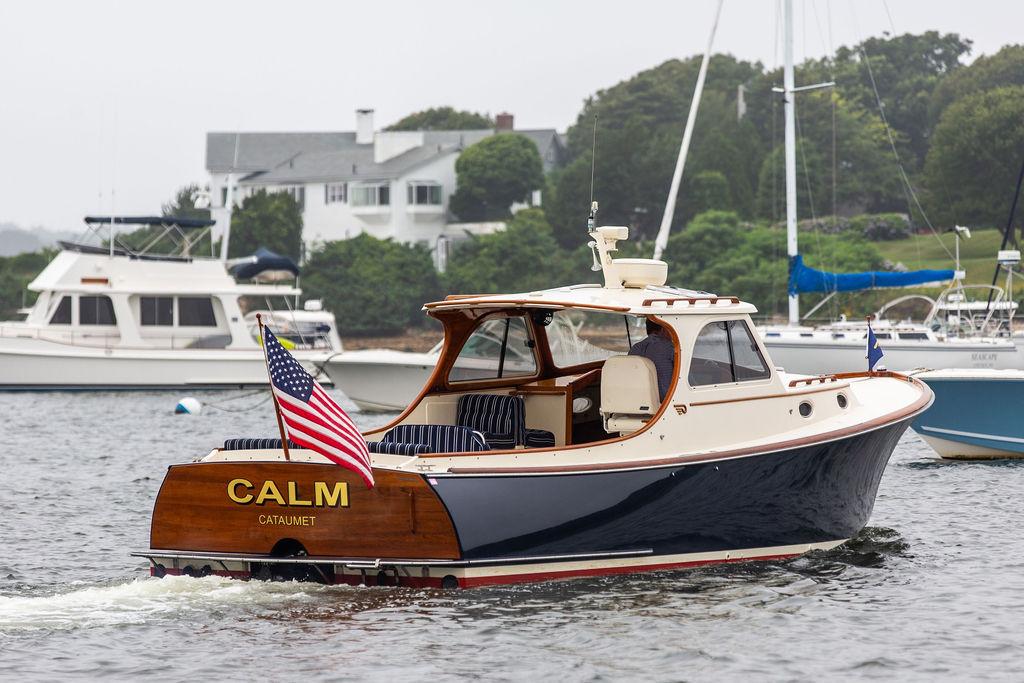 Hinckley Picnic Boat Classic 1999 Hinckley Picnic Boat Classic named "Calm" on water, displaying American flag.
