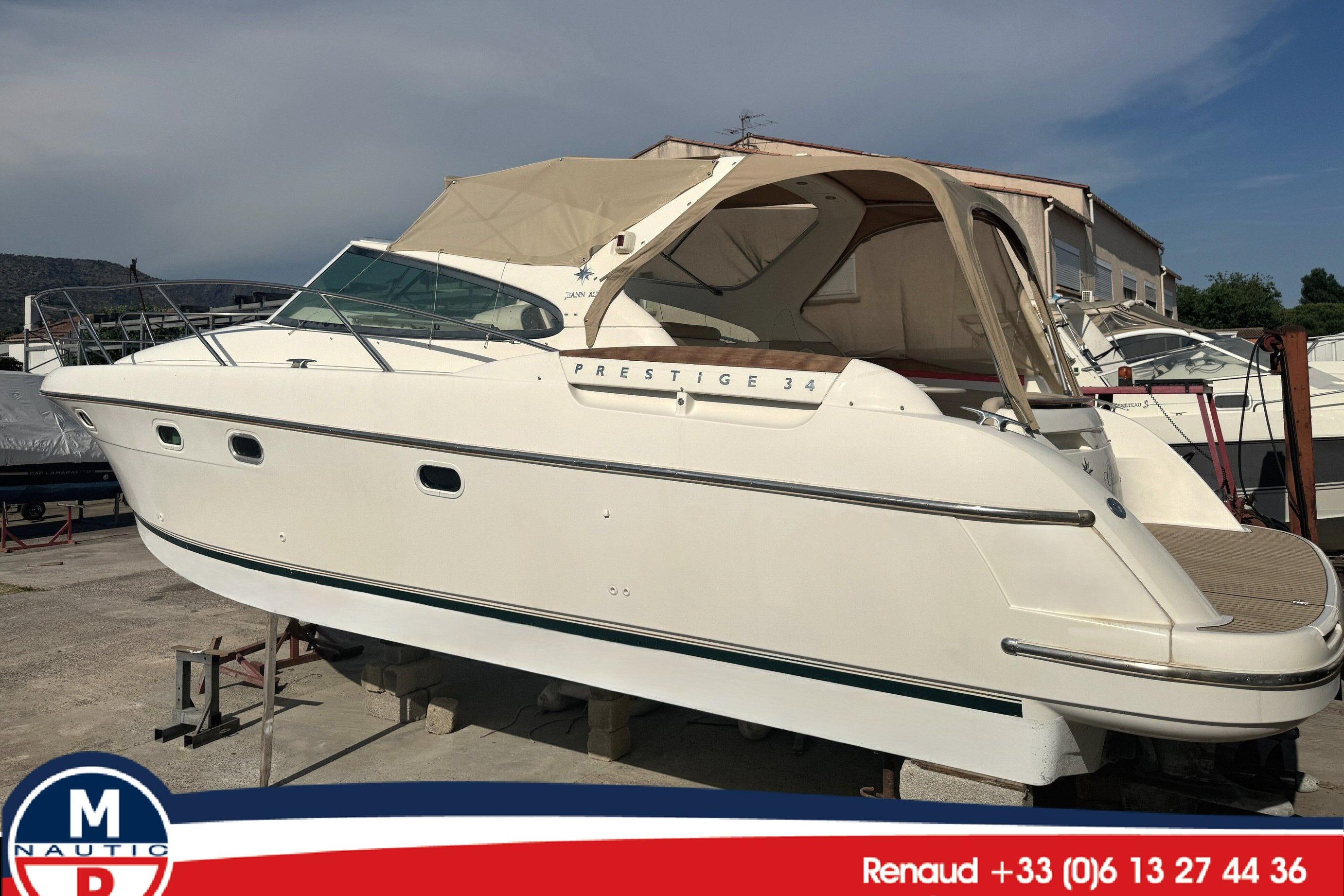 Jeanneau Prestige 34 Open 2003 Jeanneau Prestige 34 Open yacht with beige canopy, docked outdoors.