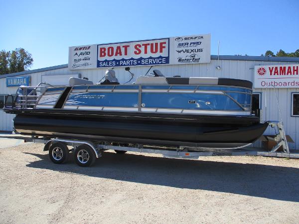 Starcraft CX 23 RL 2025 Starcraft CX 23 RL pontoon boat on trailer at dealership.