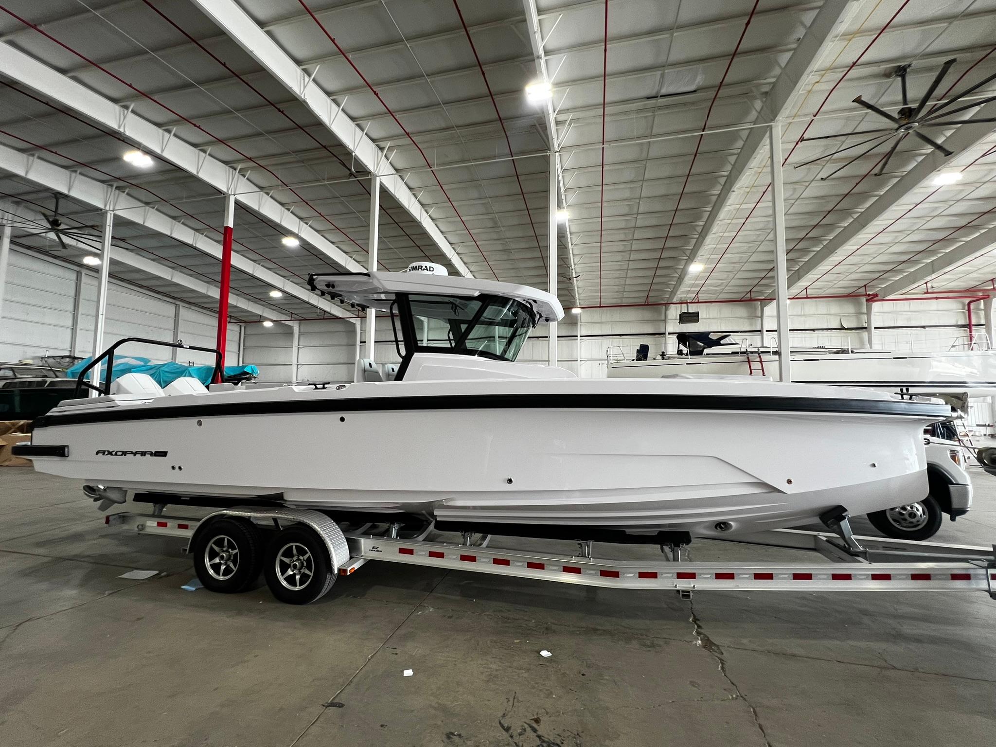 Axopar 29 CCX 2025 Axopar 29 CCX boat on trailer in indoor showroom.