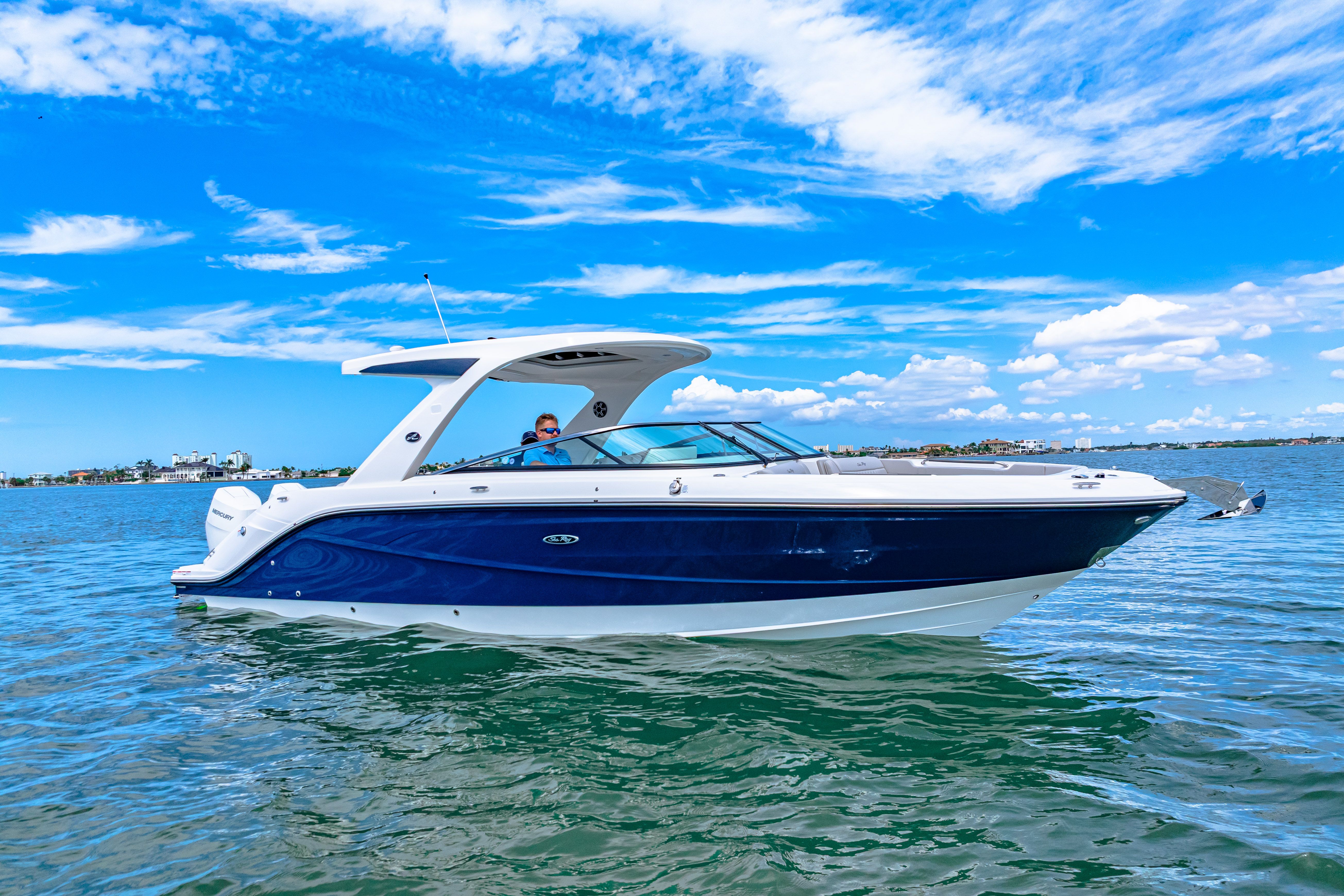 Sea Ray SLX 310 Outboard 2026 Sea Ray SLX 310 Outboard cruising on a sunny day with blue skies.