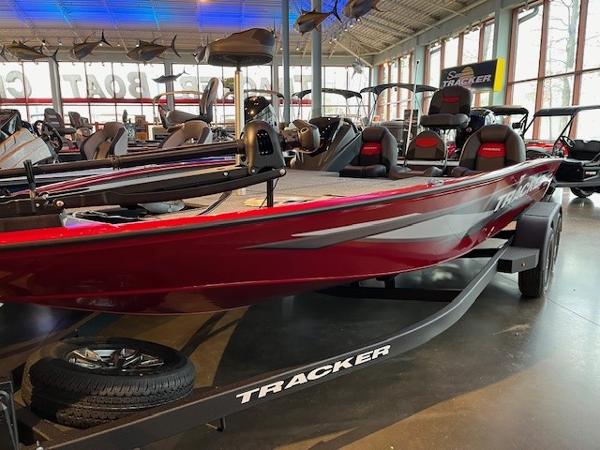 Tracker Savage 215 2025 Tracker Savage 215 boat in showroom, red exterior, on trailer.