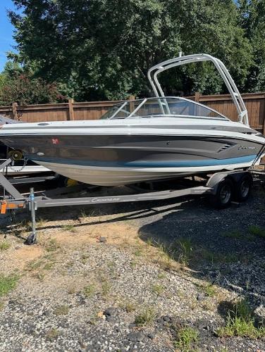 Crownline 220SS 2021 Crownline 220SS boat on trailer, parked outdoors.