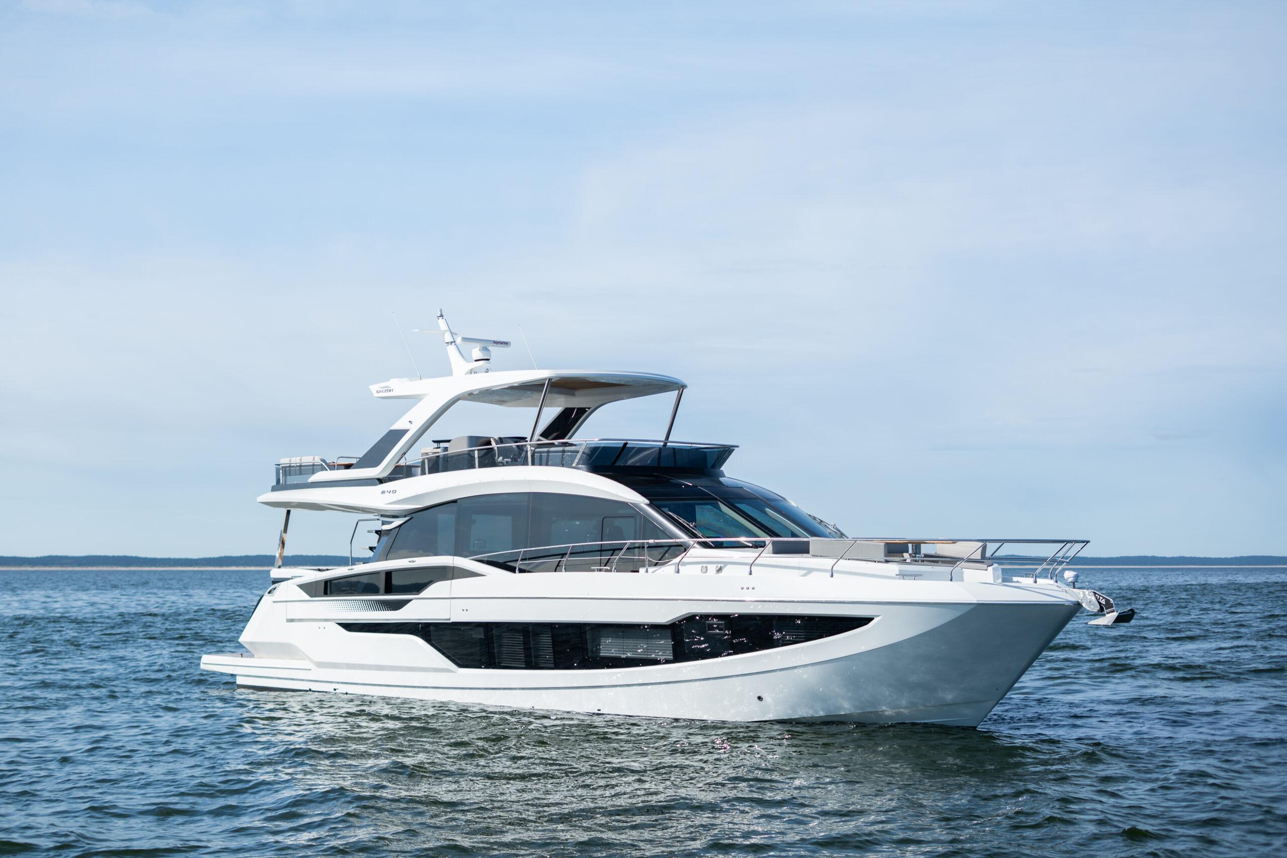 Galeon 640 Fly 2024 Galeon 640 Fly yacht cruising on open water under clear skies.