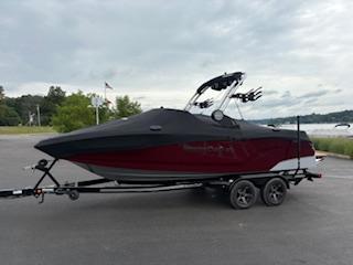MasterCraft NXT22 2024 MasterCraft NXT22 boat on trailer, parked outdoors under cloudy sky.