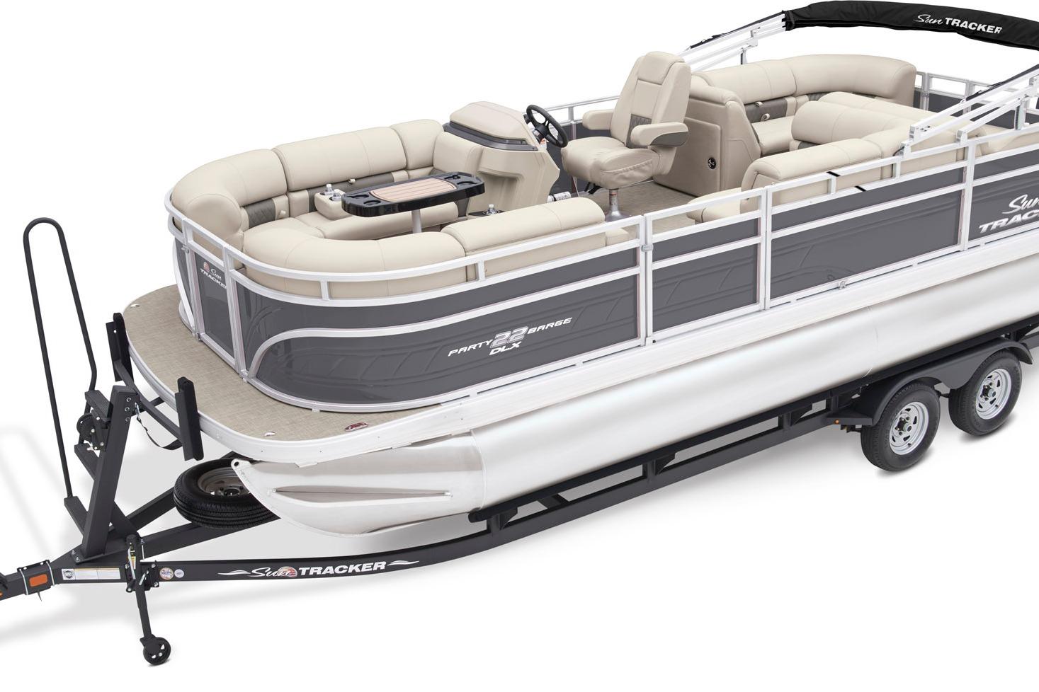 Sun Tracker Party Barge 22 RF DLX 2026 Sun Tracker Party Barge 22 RF DLX pontoon boat on trailer, featuring spacious seating.