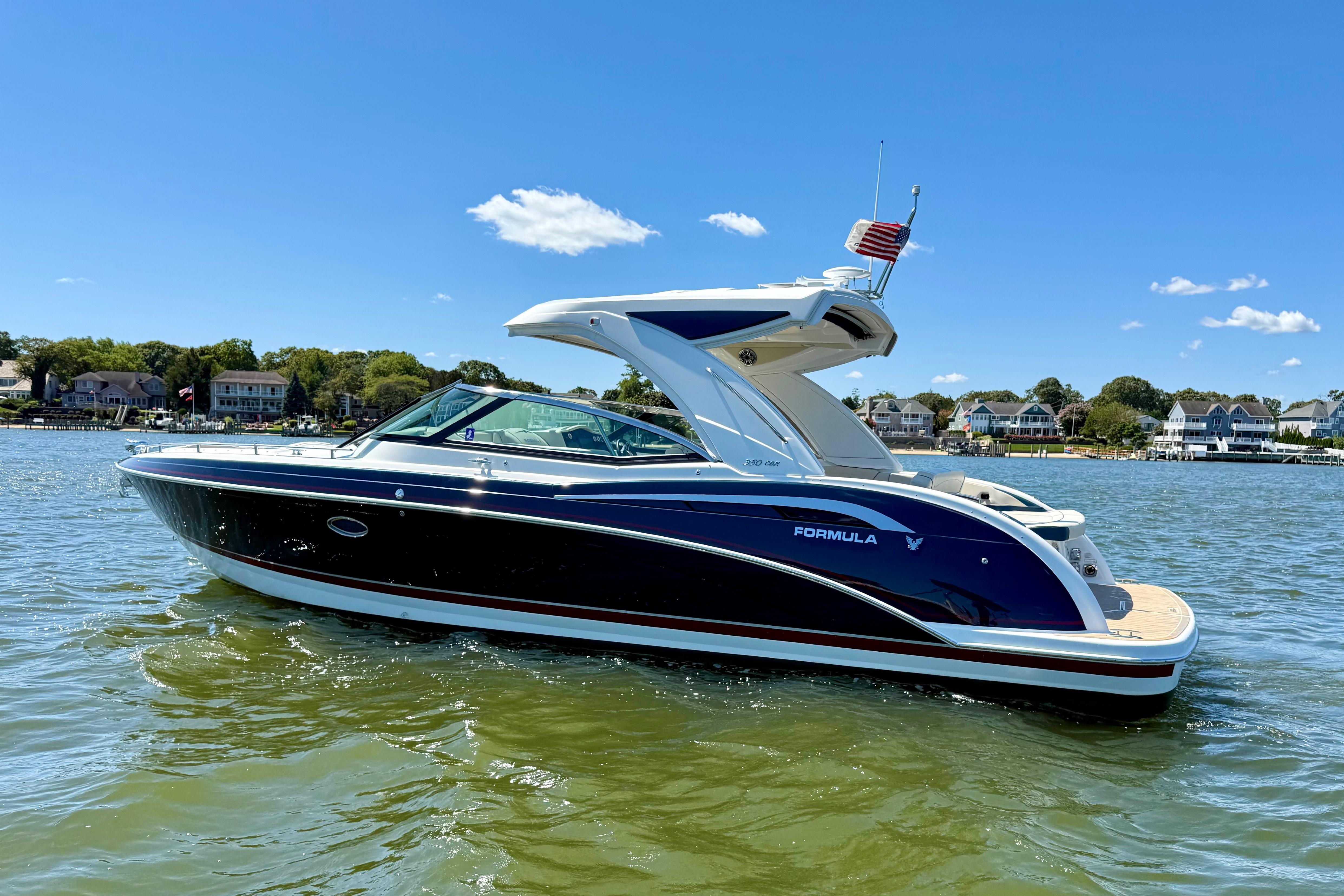 Formula 350 Crossover Bowrider 2024 Formula 350 Crossover Bowrider on water, sunny day, houses in background.