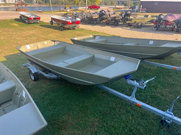 Lund 1648M 2025 Lund 1648M boats on trailers, displayed outdoors on grass.