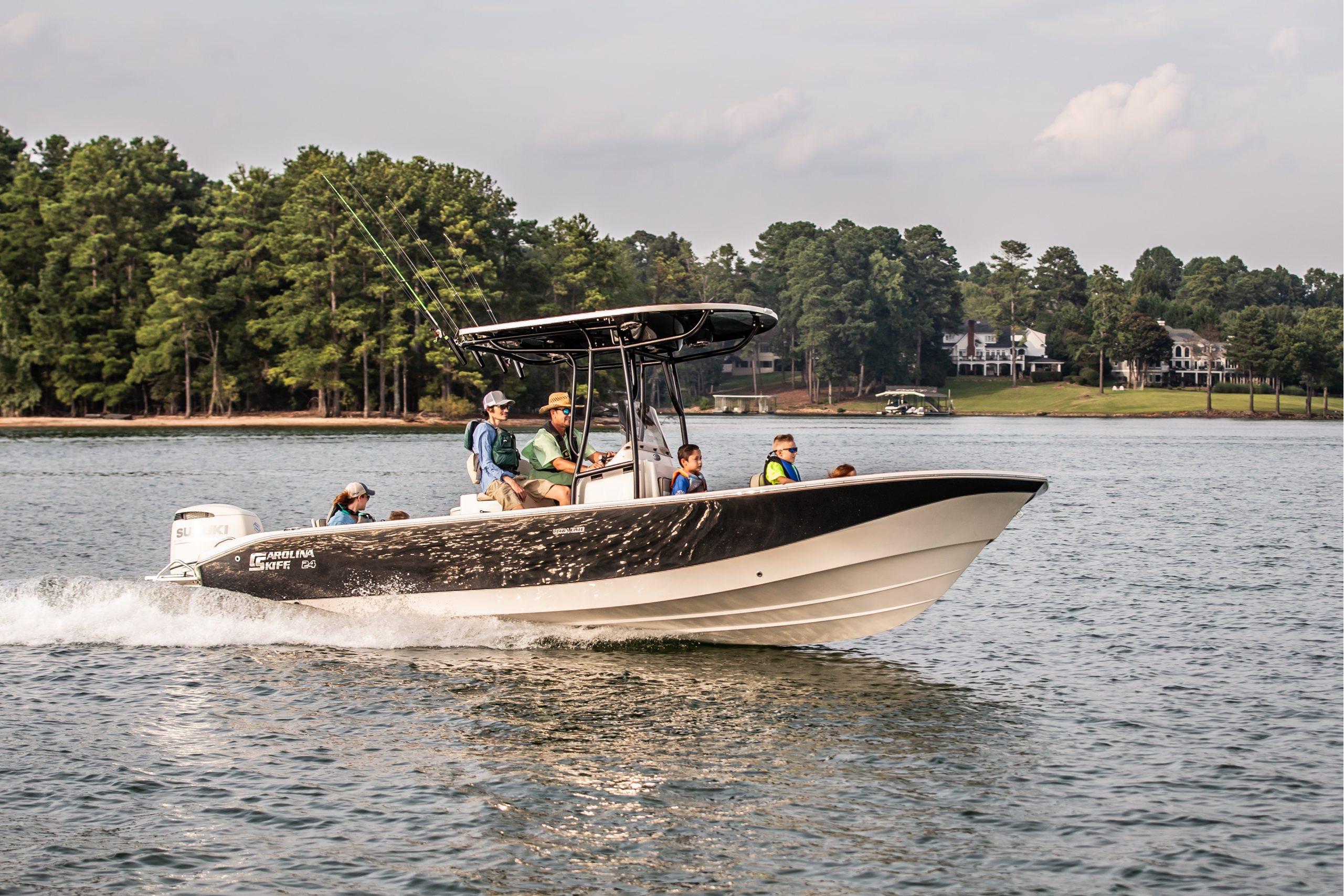 Carolina Skiff 24 Ultra Elite 2026 Carolina Skiff 24 Ultra Elite boat cruising on a lake with passengers.