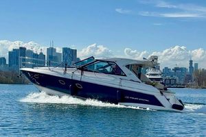 Regal 42 Sport Coupe 2012 Regal 42 Sport Coupe cruising on water with city skyline backdrop.